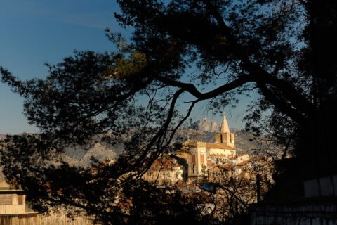 Vue de la vieille ville d'Aubagne à travers des arbres