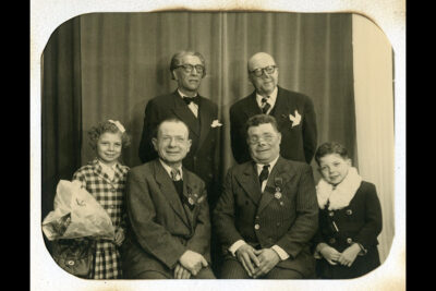 Quatre hommes dont 3 blessés au visage sont entourés d'un garçon et d'une fille avec un bouquet de fleurs - Agrandir l'image 1 sur 2, fenêtre modale